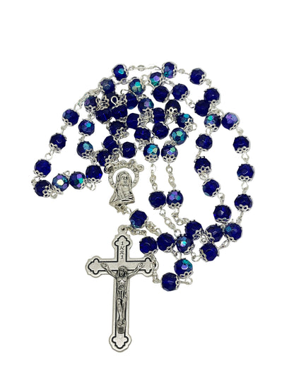 Blue crystal cut bead rosary with silver caps, Madonna centerpiece, and detailed silver crucifix.
