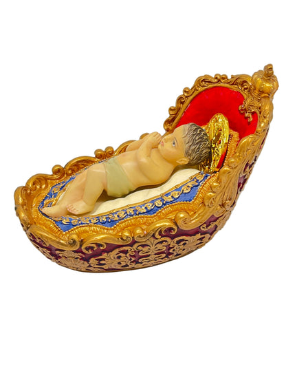 3 7/8" Advent Infant Jesus figurine with gold halo lying in ornate gold and blue hand-painted manger details