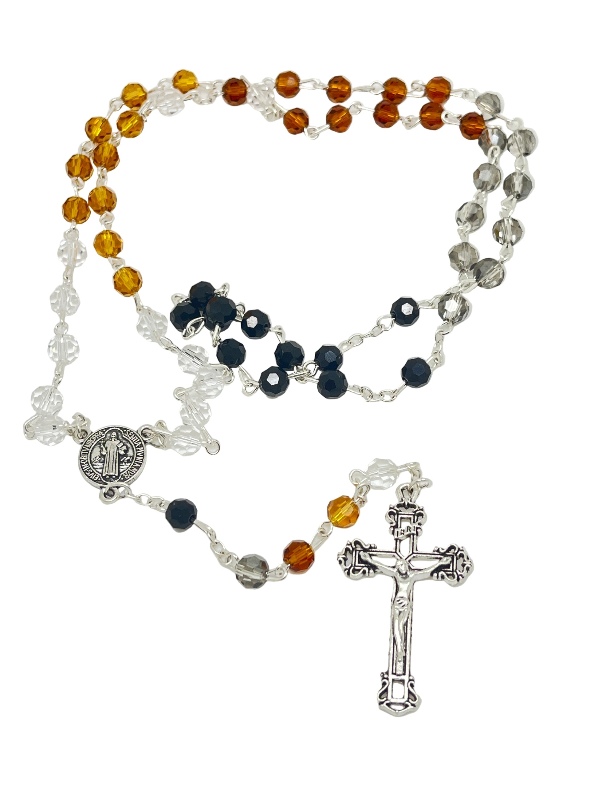 Multi-color Saint Benedict rosary with jet black, amber, brown, and clear crystals, silver crucifix, and medal centerpiece