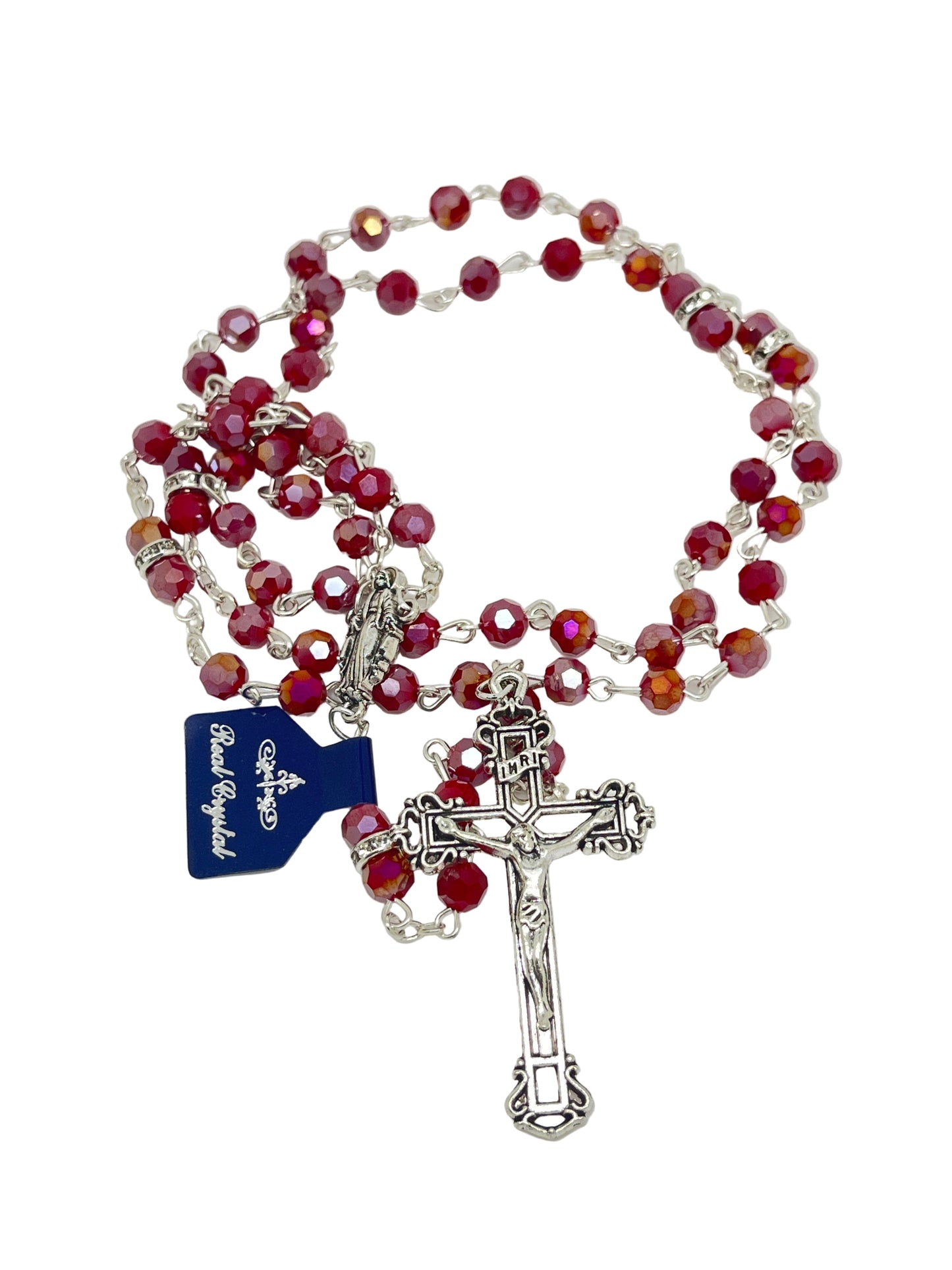Ruby red crystal rosary with silver crucifix and detailed chain links, featuring a blue brand tag and fine beadwork