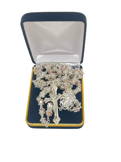 Pink capped crystal bead rosary with silver miraculous medal crowns and center, displayed in black velvet jewelry box