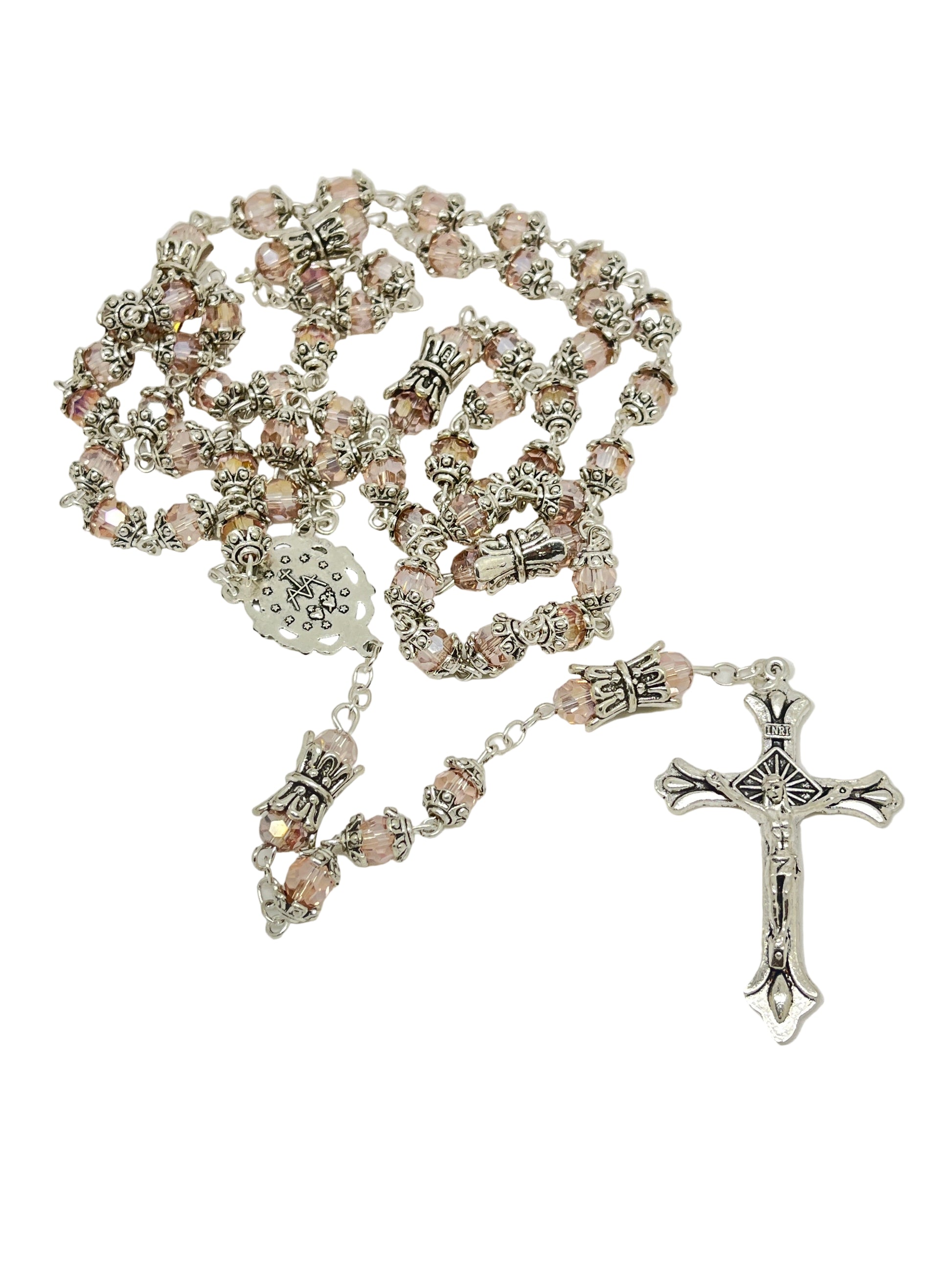Pink capped crystal rosary with silver Miraculous Medal crowns on Our Father beads and detailed silver crucifix centerpiece