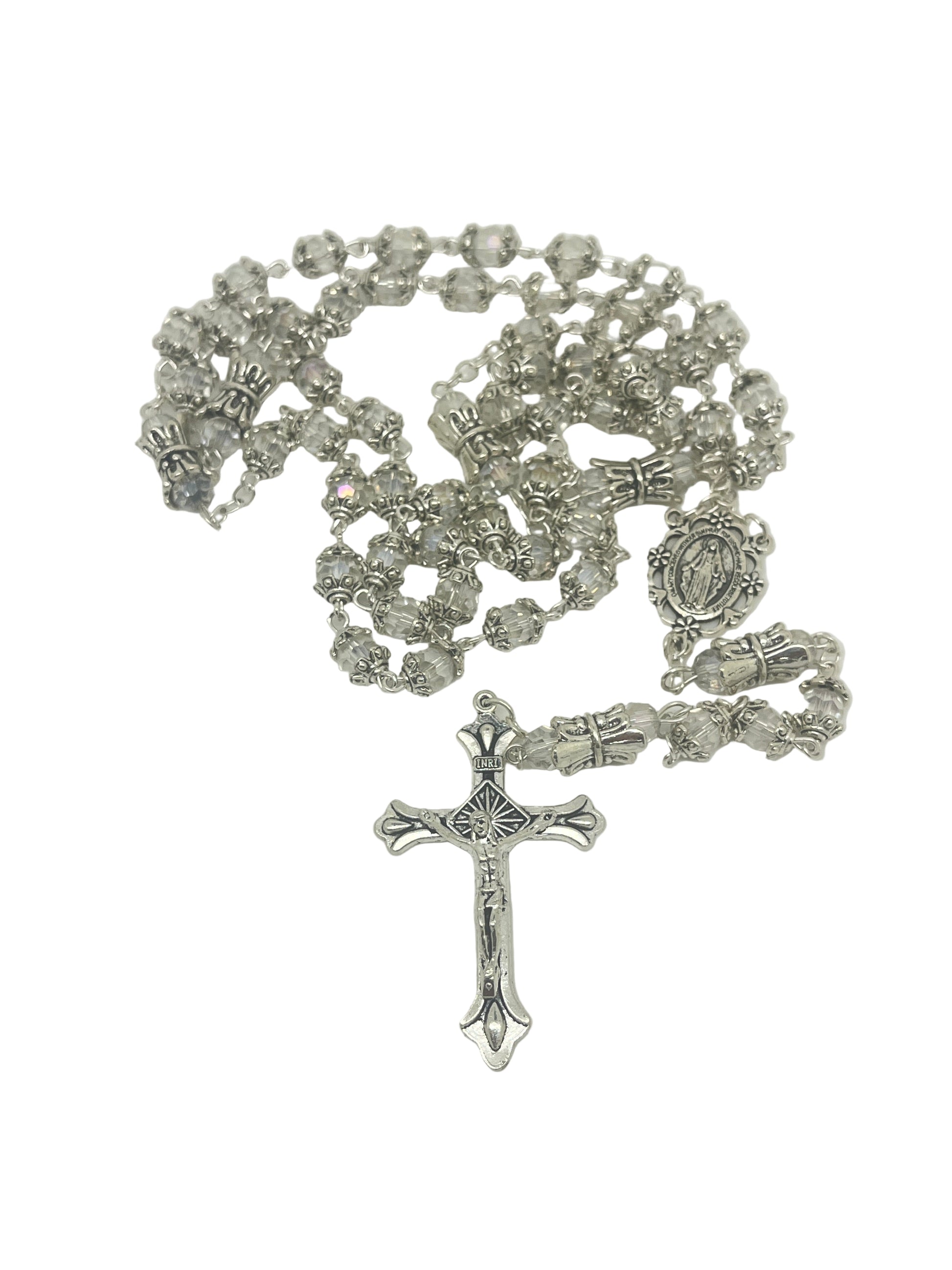 Silver capped clear crystal rosary with crowned Our Father beads and silver Miraculous Medal centerpiece on white background