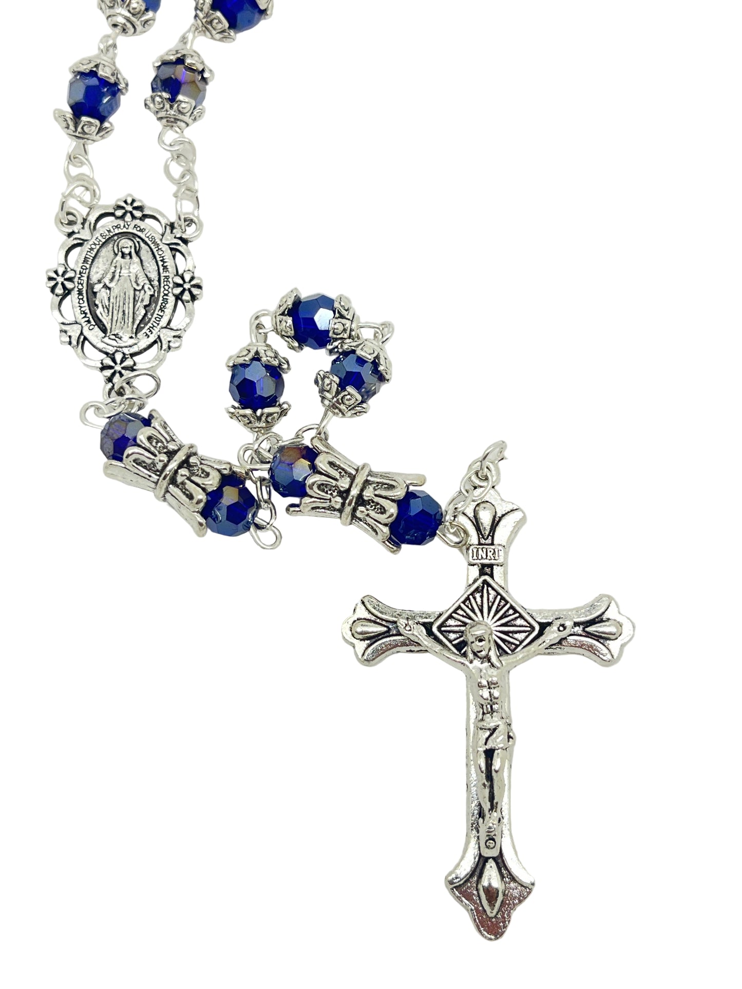 Blue capped crystal rosary with silver miraculous medal crowns and silver crucifix on white background