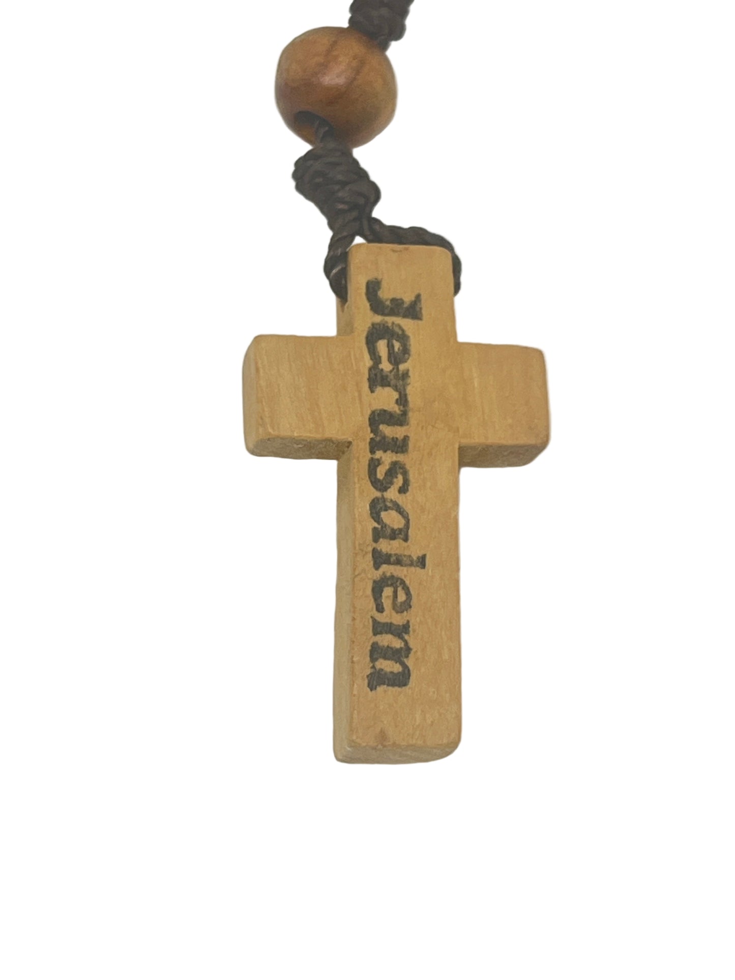 Olive wood cross pendant from Jerusalem rosary necklace with hand-carved lettering and natural wood beads on cord.