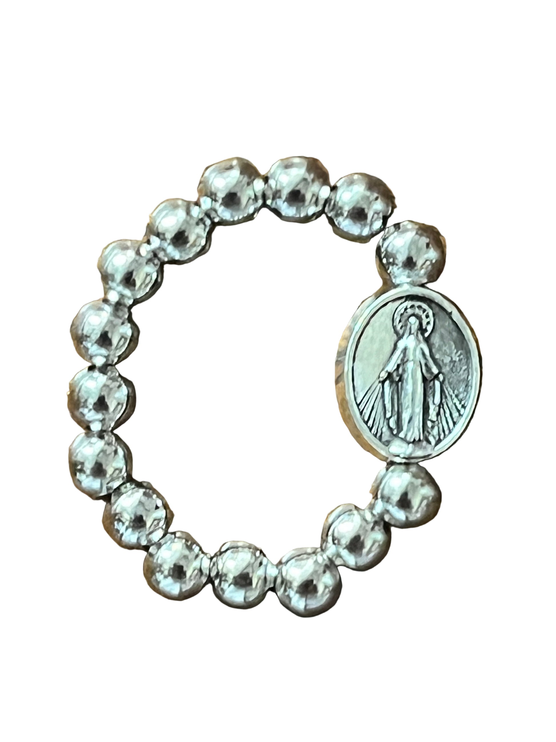 Silver stretch ring with round beads and oval Miraculous Medal charm featuring Virgin Mary image on white background