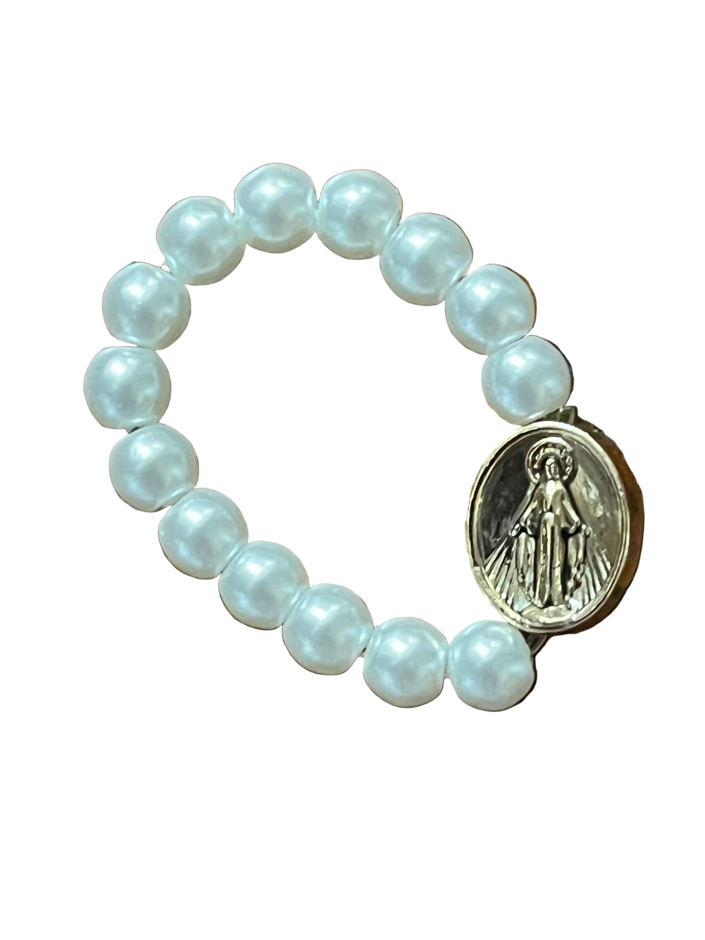 White bead stretch ring with gold Miraculous Medal charm, symbolizing faith and devotion in elegant design