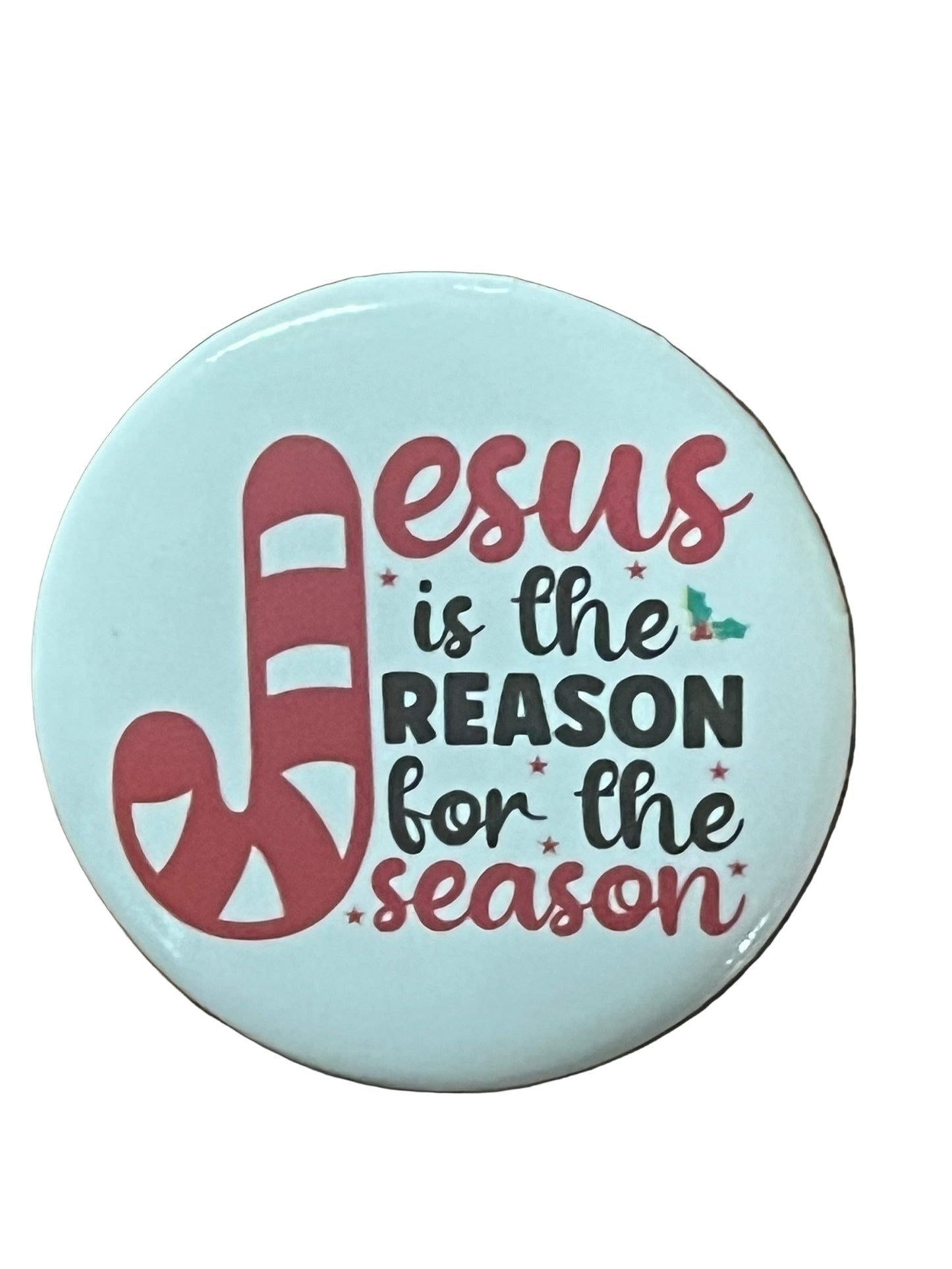 Round Christmas button with candy cane J and text "Jesus is the reason for the season" on light blue background
