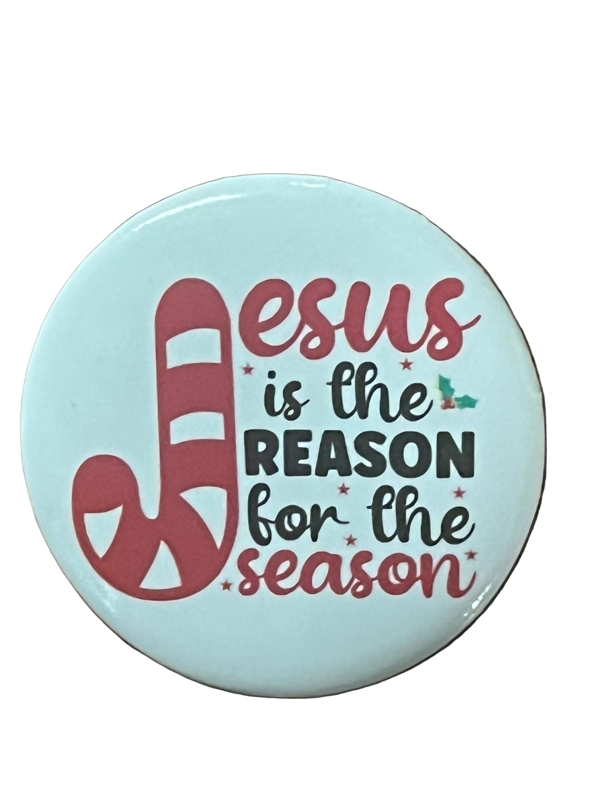Round Christmas button with candy cane J and text "Jesus is the reason for the season" on light blue background