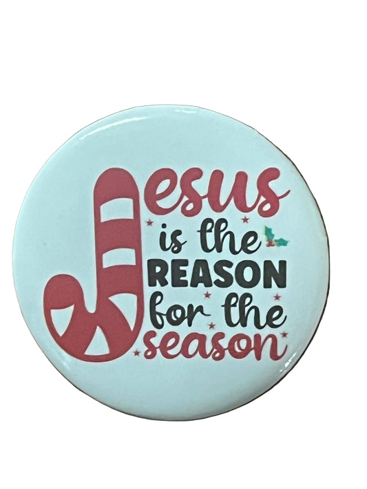Round Christmas button with candy cane J and text "Jesus is the reason for the season" on light blue background