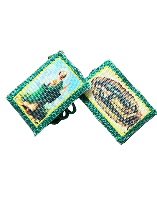 Green scapular with embroidered images of St. Jude and Our Lady of Guadalupe on green fabric background