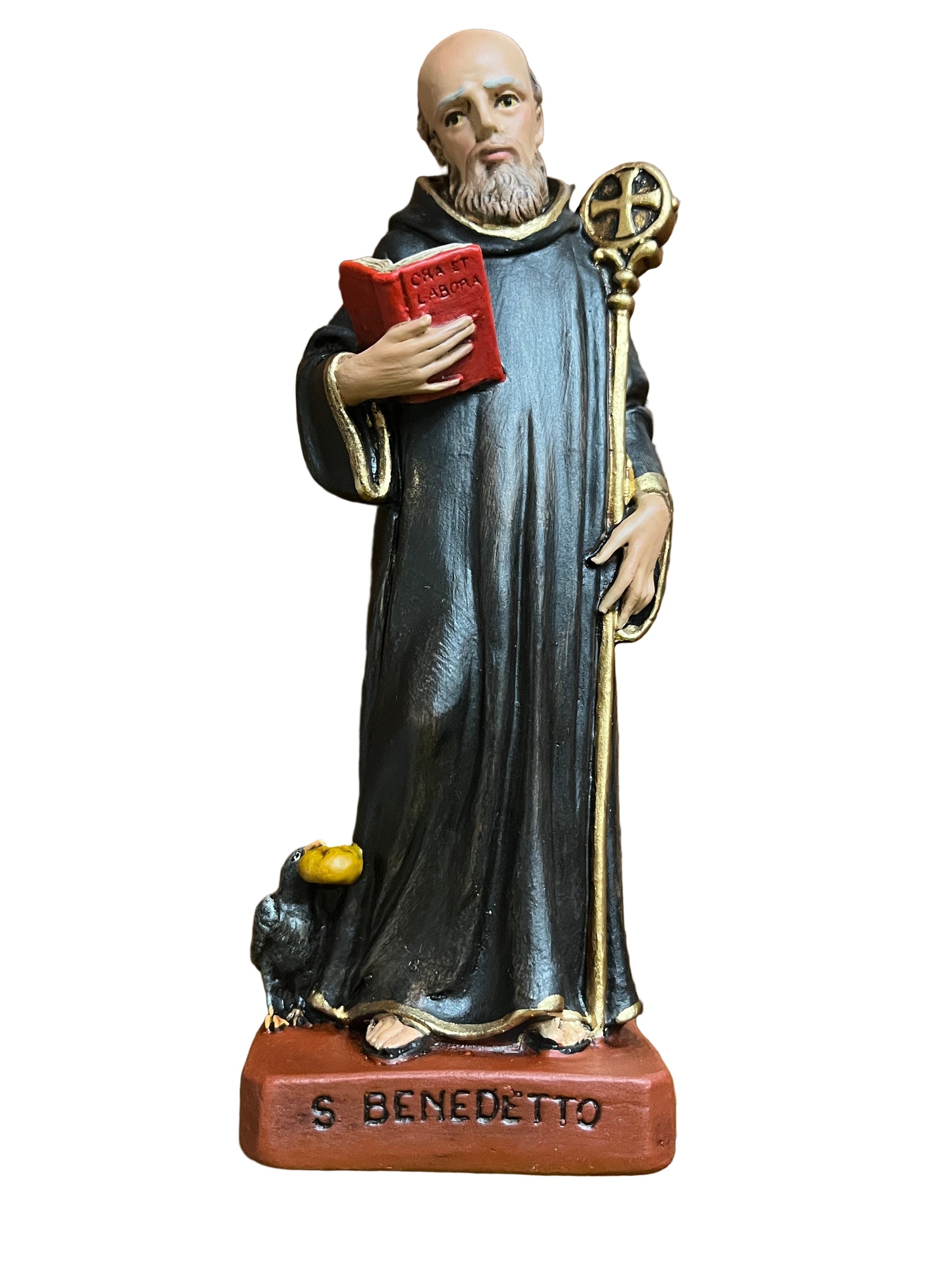6 1/2" statue of St. Benedict holding a red book and staff, dressed in black robe with gold trim on base labeled S Benedetto