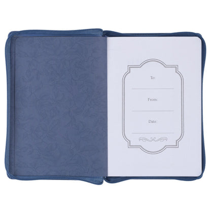 Open blue faux leather journal with zipper displaying decorative floral inner cover and gift inscription page