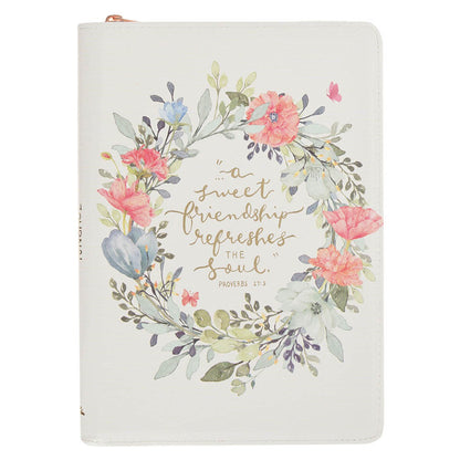 Faux leather journal with bright floral wreath and Proverbs 27:9 quote on white background with zipper closure