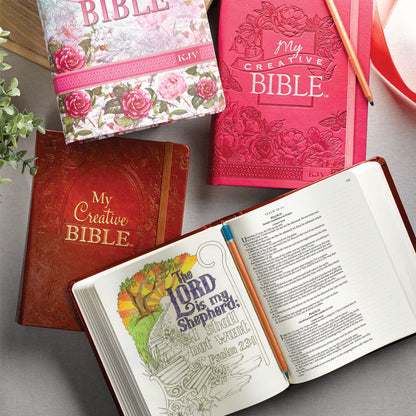 Bright pink faux leather hardcover KJV My Creative Bible with embossed floral design and decorative illustrated scripture pages
