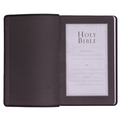 Black faux leather King James Version gift edition Bible open to presentation page with space for name and date