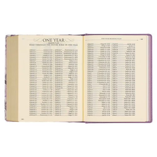 Open Purple Floral Faux Leather hardcover Bible showing one-year reading plan with scripture references on cream pages