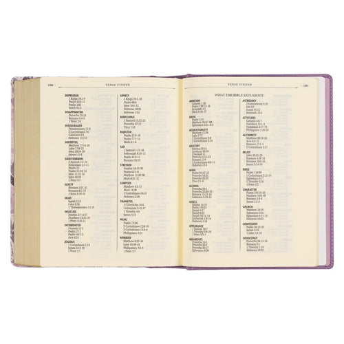 Open Purple Floral Faux Leather Hardcover Bible showing verse finder pages with clear text on white paper