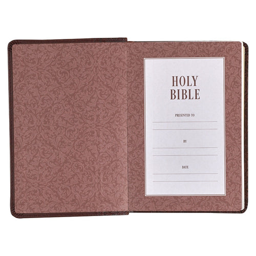 Medium brown faux leather King James Bible open to presentation page with floral textured inner cover design