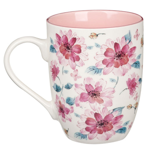Ceramic coffee mug with pink floral design and soft pink interior, delicate and feminine style on white background