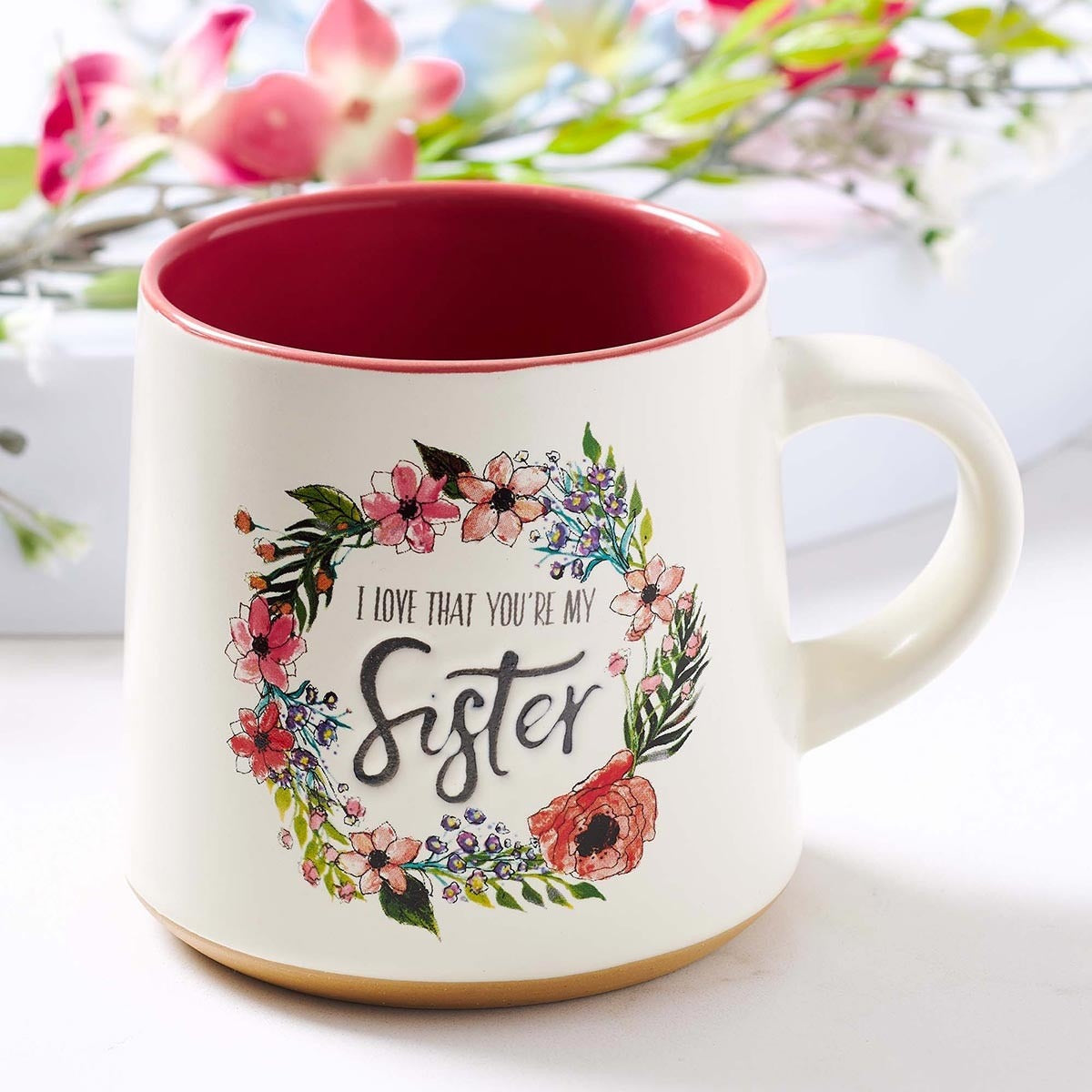 Ceramic Sister coffee mug with floral wreath design, clay dipped base, and red interior, Ecclesiastes 4:9 inscription