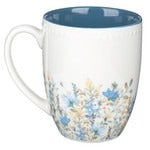 Faith petite floral mug with creamy white exterior, blue and tan flowers, bluebirds, butterflies, and blue block letter sentiment