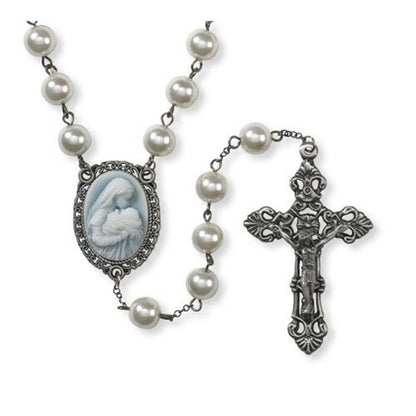 Rosary with faux pearl beads, ornate silver crucifix, and cameo centerpiece of Mary kissing baby Jesus on blue background