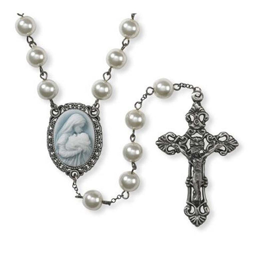Rosary with faux pearl beads, ornate silver crucifix, and cameo centerpiece of Mary kissing baby Jesus on blue background