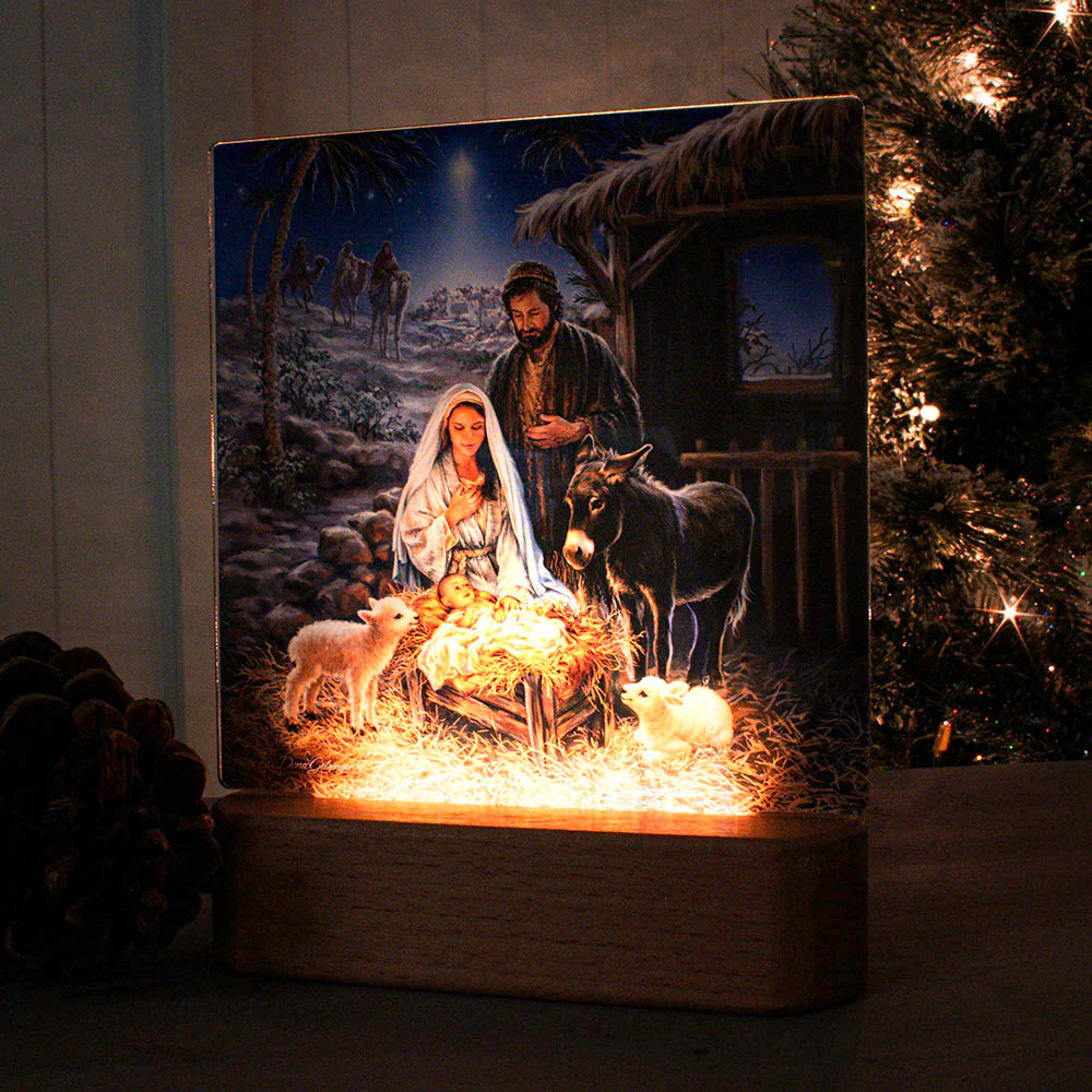 LED nightlight tabletop plaque depicting nativity scene with Mary, Joseph, baby Jesus, animals, and starry night background