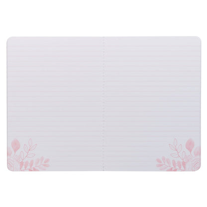 Open pink floral large notebook with lined pages and delicate flower illustrations in corners