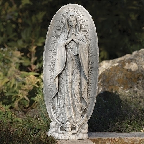 18.75" Our Lady of Guadalupe garden statue with detailed robe and halo, standing on cherub base in outdoor setting