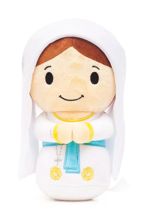 Plush doll of Our Lady of Lourdes with white veil, blue sash, yellow details, and hands clasped in prayer