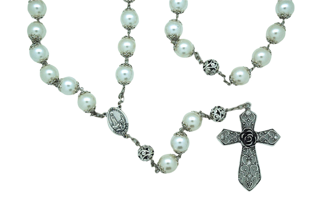 Pearl wall rosary with silver caps, detailed centerpiece medal, and ornate silver-tone cross with floral design