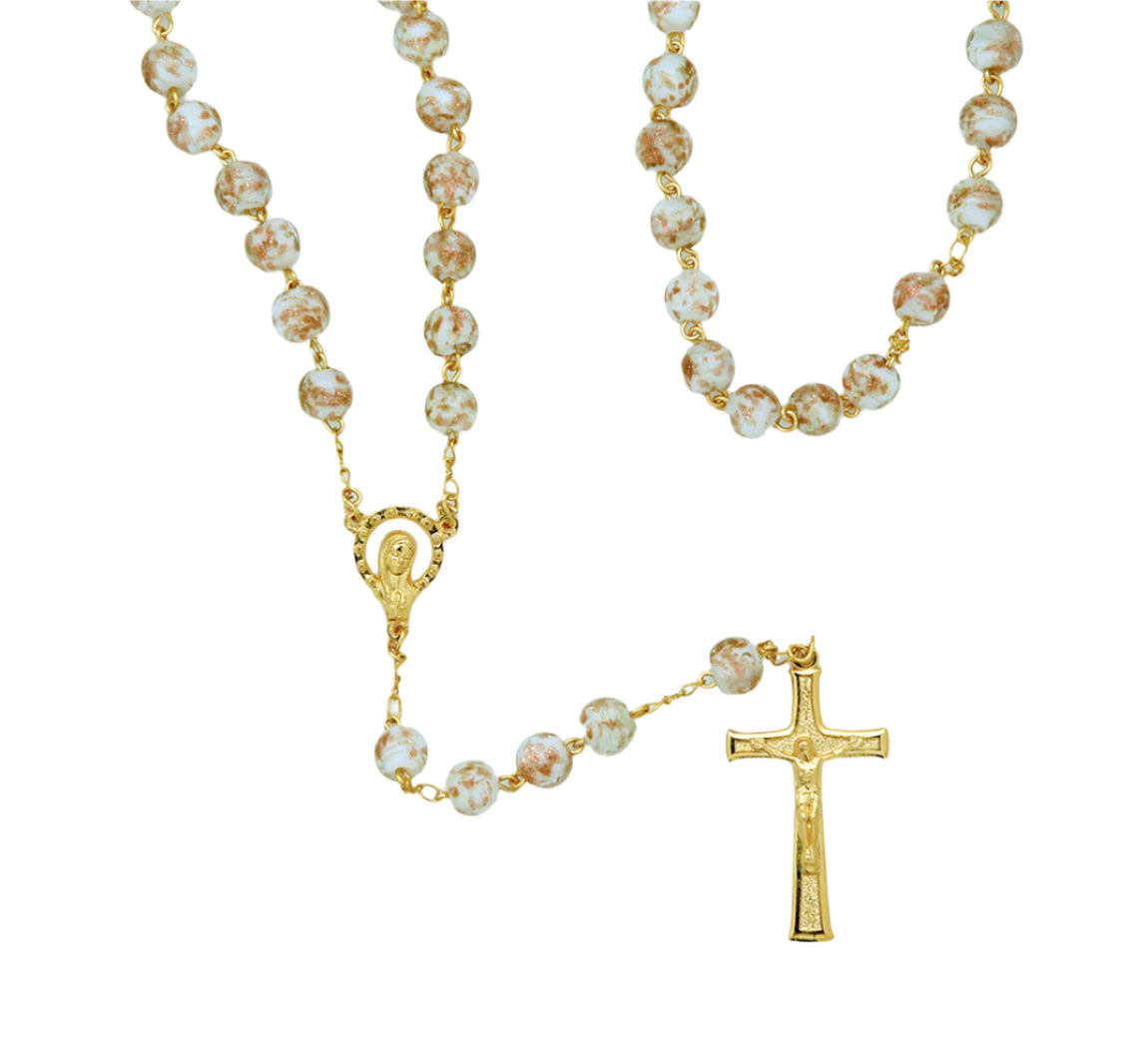 Luminous Fatima rosary with white glass beads, gold-tone chain, detailed centerpiece, and crucifix pendant