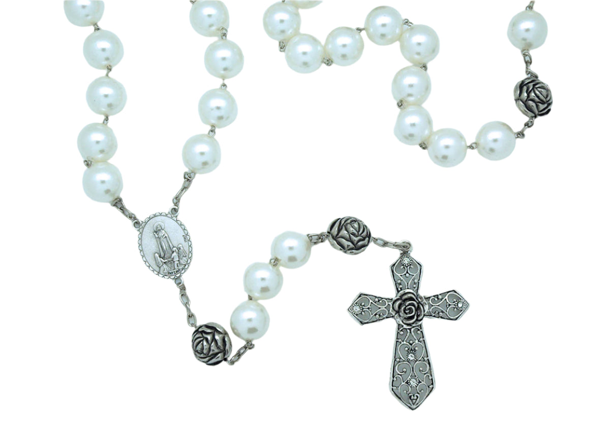 Pearl wall rosary with lustrous beads, detailed silver cross, and floral connector medallion for home decor and devotion