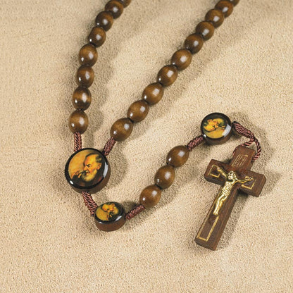 Padre Pio wood rosary with round image beads and brown crucifix with gold-tone corpus on beige background