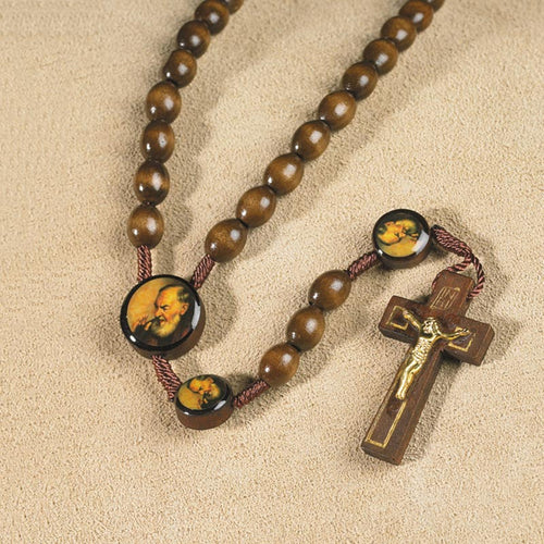 Padre Pio wood rosary with round image beads and brown crucifix with gold-tone corpus on beige background
