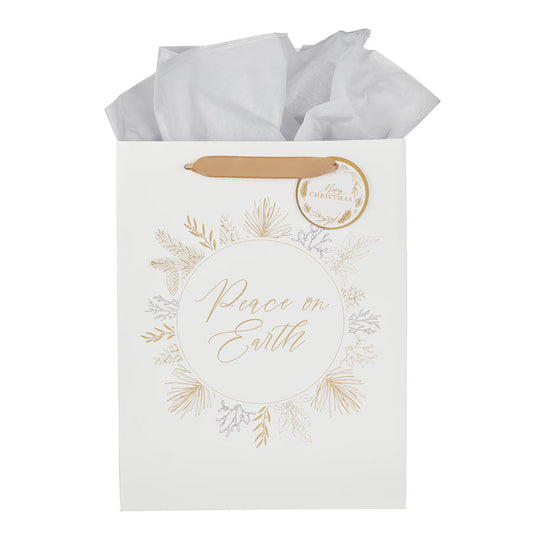 White gift bag with gold pine branch wreath and "Peace on Earth" script, tan handle, and matching round gift tag