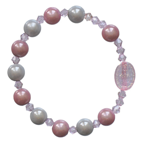 Children's rosary bracelet with pink and pearl beads, featuring a Miraculous Medal centerpiece on stretch cord design.
