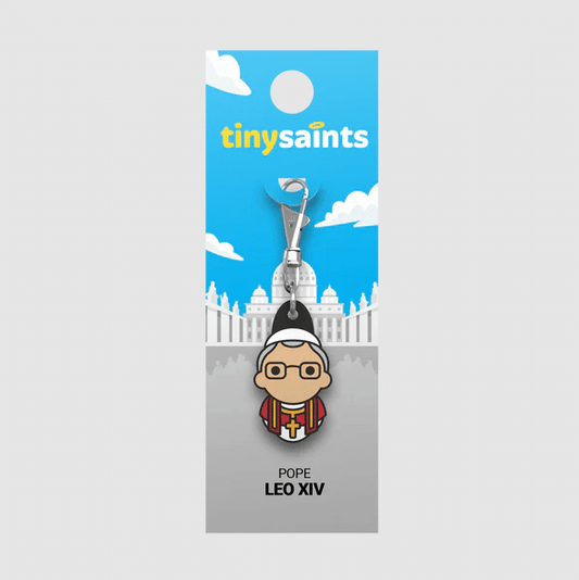 Pope Leo XIV Tiny Saints charm with colorful papal attire on blue and gray card backing with Vatican illustration background