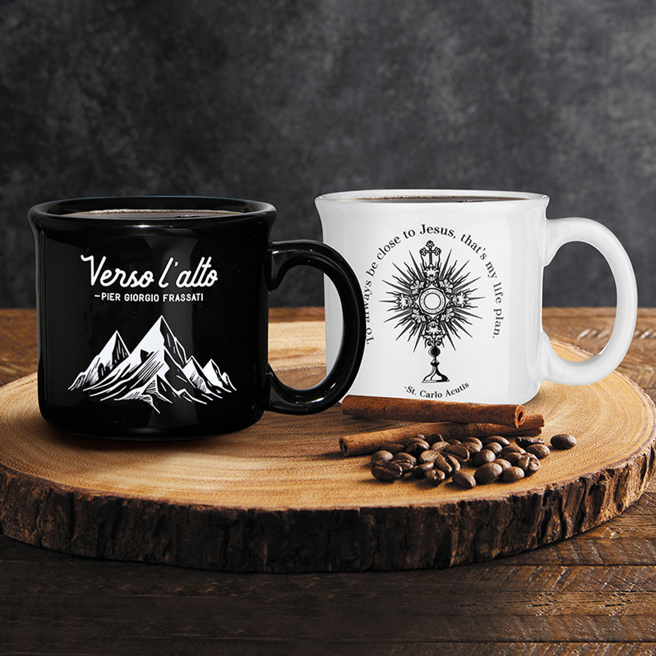 Black and white Verso l'Alto St. Pier Giorgio Frassati ceramic mugs with mountain and religious designs on wooden slab