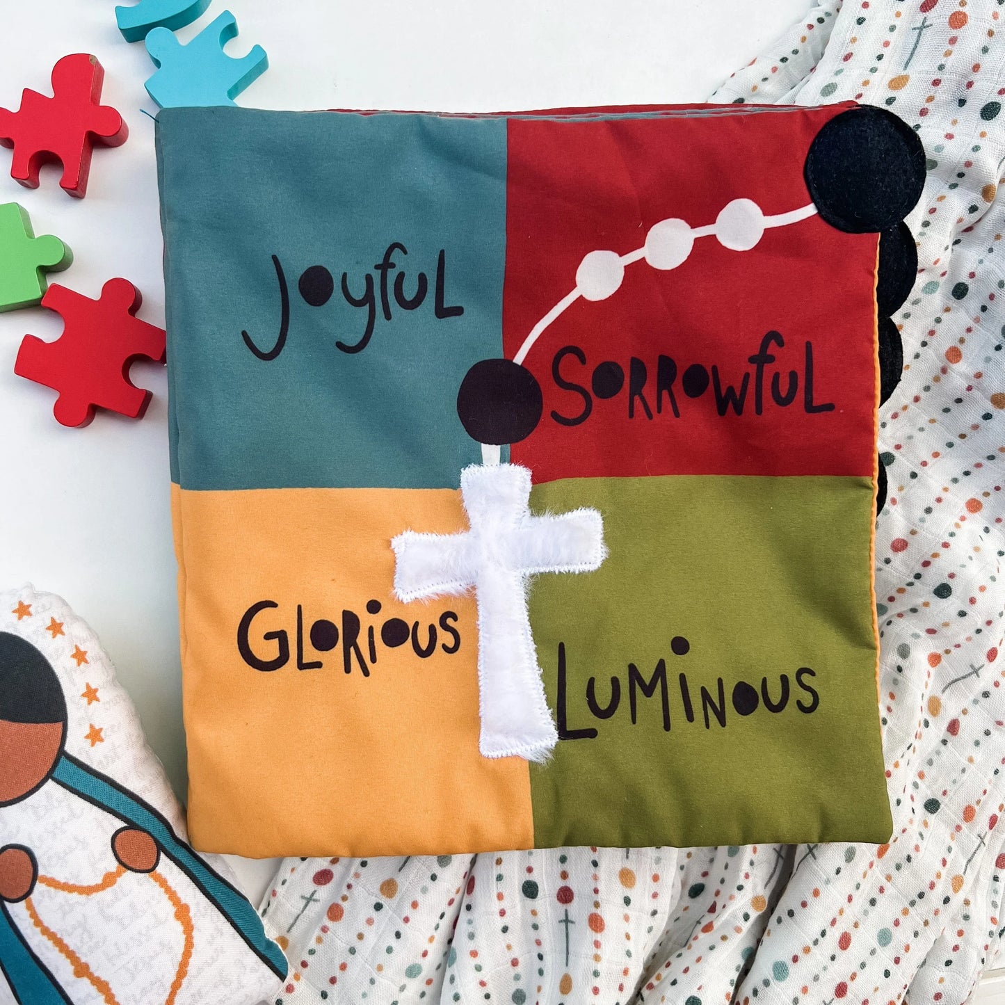 Colorful fabric Rosary Mass Quiet Book with joyful, sorrowful, glorious, luminous mysteries and white cross applique