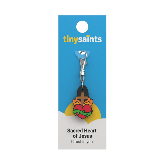 Sacred Heart of Jesus Tiny Saint keychain with heart, flames, crown of thorns, and cross on blue and white card packaging