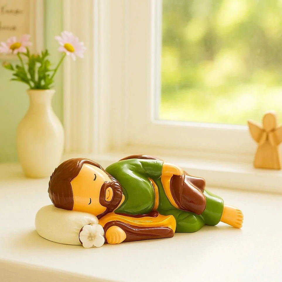 3.55" Sleeping Saint Joseph collector's edition figurine in green and brown resting on white pillow with flower detail