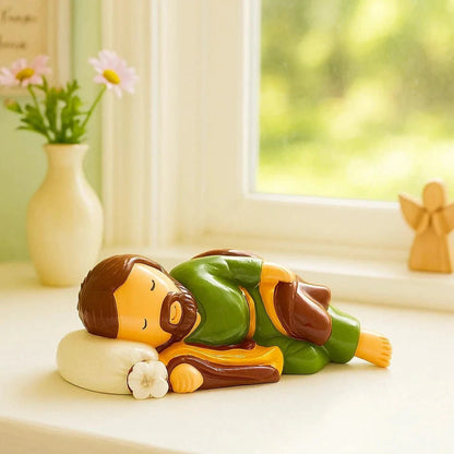 3.55" Sleeping Saint Joseph collector's edition figurine in green and brown resting on white pillow with flower detail