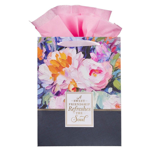 Large portrait gift bag with watercolor garden floral design, pink tissue paper, and friendship quote on front panel