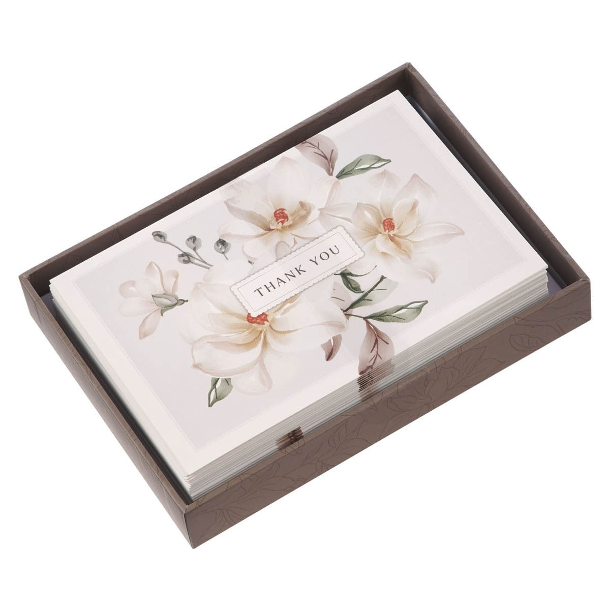 Set of white magnolia thank you note cards with delicate floral design and elegant script in decorative box