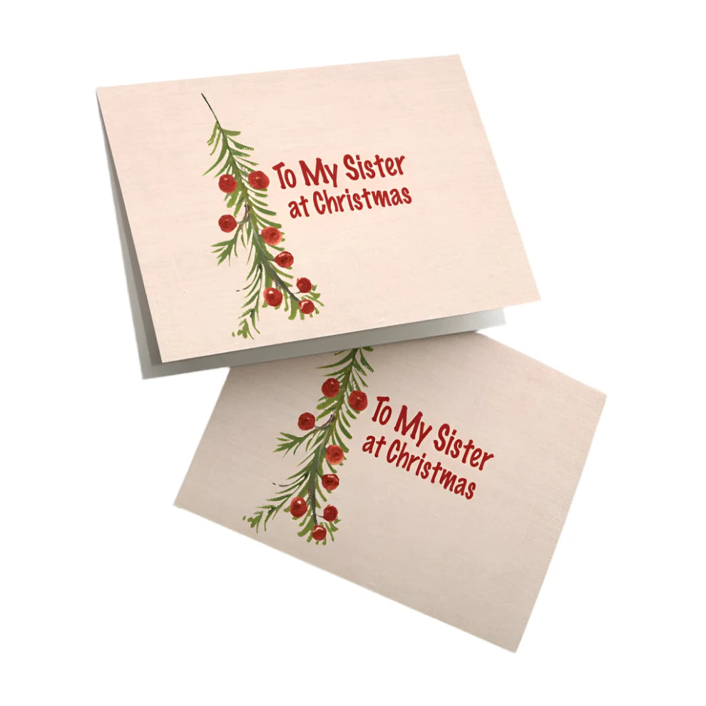 Christmas card for sister with simple evergreen and red berry design and "To My Sister at Christmas" text on cream background
