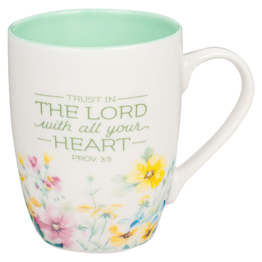 Ceramic coffee mug with Proverbs 3:5 verse in green and watercolor wildflower design on white background