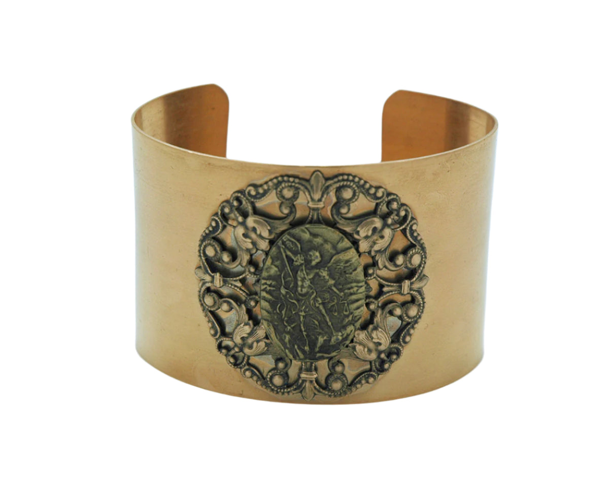 Vintage-style wide cuff bracelet with detailed St. Michael the Archangel medal and antique gold finish